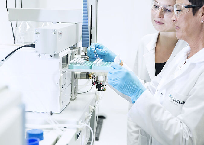 Performing food analysis in the laboratory: laboratory technicians during the examination for residues and contaminants