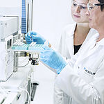 Performing food analysis in the laboratory: laboratory technicians during the examination for residues and contaminants