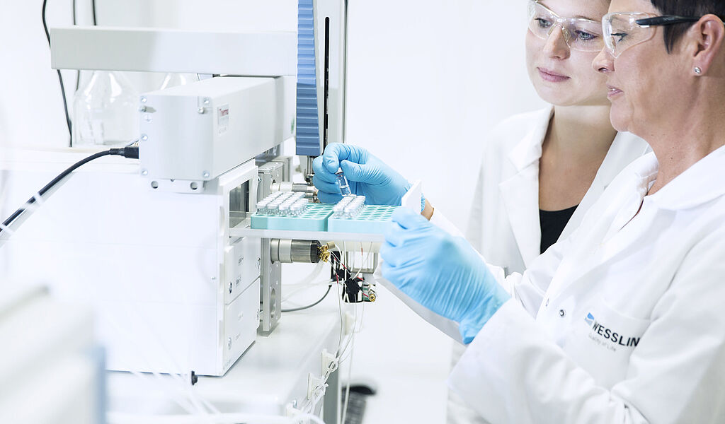 Performing food analysis in the laboratory: laboratory technicians during the examination for residues and contaminants