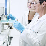 Performing food analysis in the laboratory: laboratory technicians during the examination for residues and contaminants