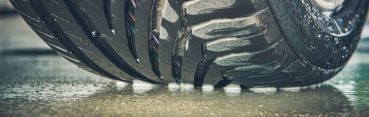 Car tyres on a wet road 